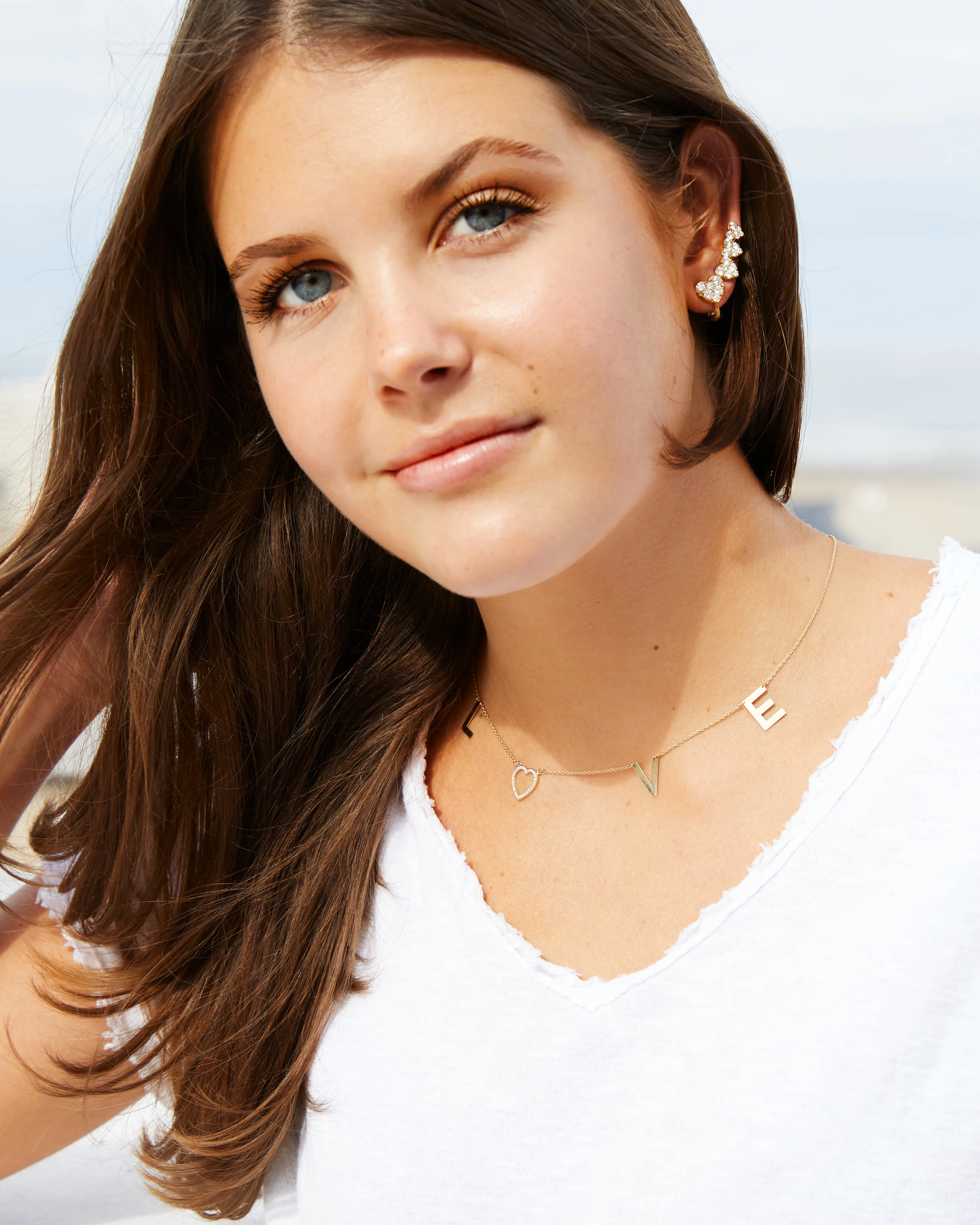 Yellow gold L-O-V-E necklace with a diamond heart